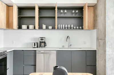 a kitchen with gray cabinets and a sink at Downtown 1BR w Pool Gym WD nr Staples Center LAX-547 in Los Angeles