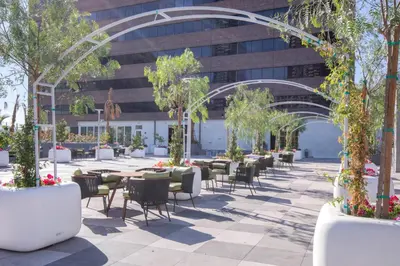 a courtyard with tables and chairs in front of a building at Downtown 1BR w Pool Gym WD nr Staples Center LAX-547 in Los Angeles