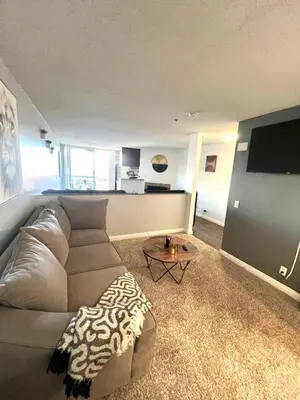 a living room with a couch and a flat screen tv at Amazing Universal Studios Loft FREE parking in Los Angeles