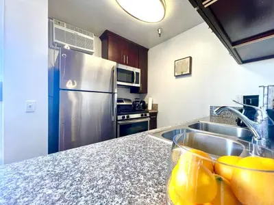 a kitchen with a sink and a stainless steel refrigerator at Amazing Universal Studios Loft FREE parking in Los Angeles