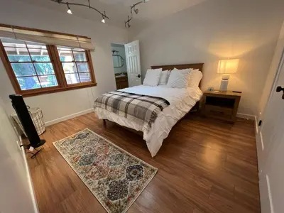 a bedroom with a bed and a window and a rug at Villa La Reforma - Newly Designed 4BR HOUSE & POOL in Los Angeles by Topanga in Los Angeles