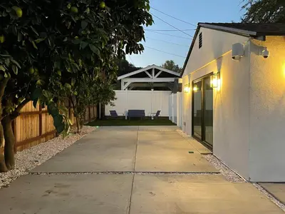 a walkway leading into a backyard with a white building at Gated private house with own parking Sherman Oaks in Los Angeles