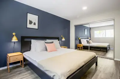 a bedroom with a large bed with blue walls at W Hollywood 1BR nr Shops Melrose LAX-210 in Los Angeles