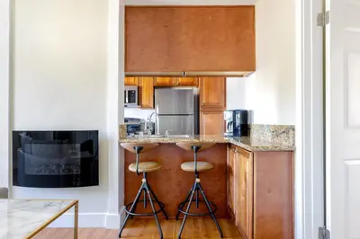 a kitchen with a counter with stools in it at Marina Del Rey 1BR nr marina shops dining LAX-467 in Los Angeles