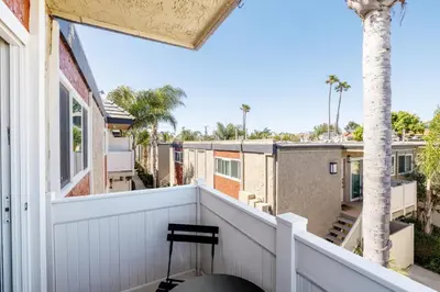 a balcony with a chair and a palm tree at Marina Del Rey 1BR nr marina shops dining LAX-467 in Los Angeles