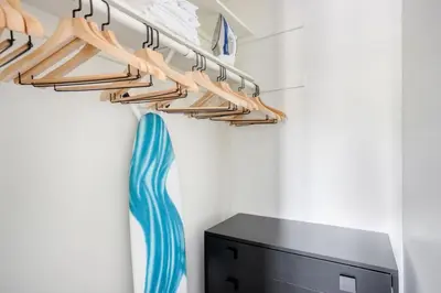 a closet with wooden hangers and a blue tie at Pasadena 1BR w Gym Pool nr Colorado Ave LAX-862 in Pasadena