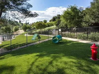 a playground with a red fire hydrant next to a fence at Burbank 1BR w Pool WD Gym nr TJ WF LAX-788 in Los Angeles