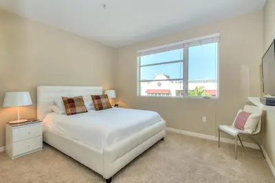 a bedroom with a white bed and a window at Awesome Top Floor 2-Bedroom with Balcony in Los Angeles