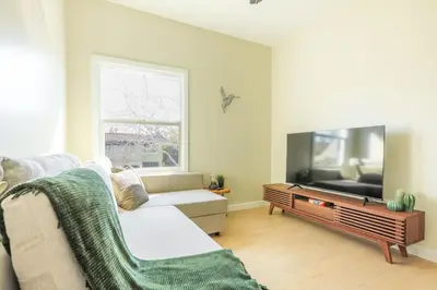 a living room with a couch and a flat screen tv at Cozy Sunny Brand-new Apt 1 Block From The Beach in Long Beach