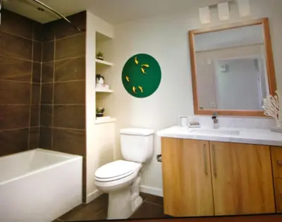 a bathroom with a toilet and a sink and a mirror at Masterpiece 2-Bedroom with Balcony, Pool, and Spa in Los Angeles