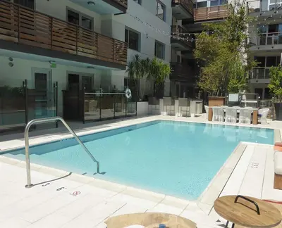 a large swimming pool in the middle of a building at Masterpiece 2-Bedroom with Balcony, Pool, and Spa in Los Angeles