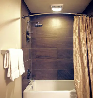 a bathroom with a shower with a tub and a toilet at Masterpiece 2-Bedroom with Balcony, Pool, and Spa in Los Angeles