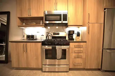 a kitchen with a stove and a microwave at Masterpiece 2-Bedroom with Balcony, Pool, and Spa in Los Angeles