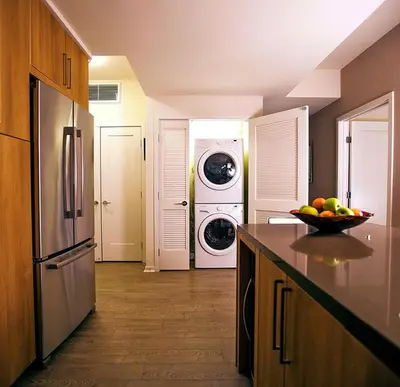 a kitchen with a washing machine and a washer and dryer at Masterpiece 2-Bedroom with Balcony, Pool, and Spa in Los Angeles