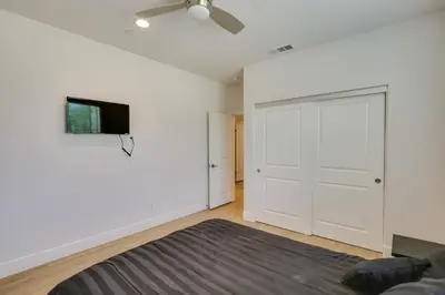 a bedroom with a bed and a tv on a wall at Pet-Friendly Paramount Home, 16 Mi to Los Angeles! in Paramount