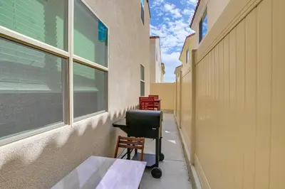 a hallway with a desk and a chair next to a building at Pet-Friendly Paramount Home, 16 Mi to Los Angeles! in Paramount