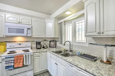 a kitchen with white cabinets and a sink at 1 Mi to SoFi! Convenient Inglewood Condo in Inglewood