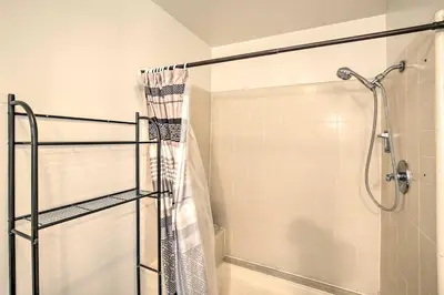 a bathroom with a shower with a shower curtain at 1 Mi to SoFi! Convenient Inglewood Condo in Inglewood