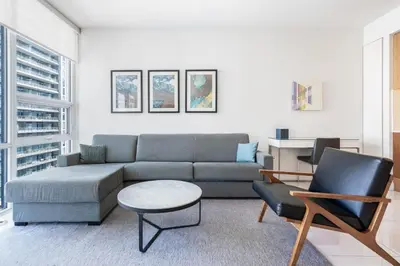 a living room with a couch and a table and chairs at Level Downtown LA South Olive in Los Angeles