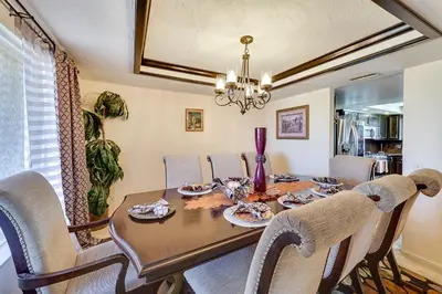 a dining room with a table and chairs at Spacious Apple Valley Home with Pool and Yard! in Apple Valley