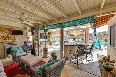 a living room with a table and chairs at Spacious Apple Valley Home with Pool and Yard! in Apple Valley