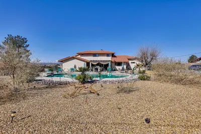 a house with a swimming pool in the desert at Spacious Apple Valley Home with Pool and Yard! in Apple Valley