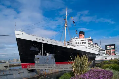 a cruise ship is docked in a harbor at The Varden - A Self-Service Micro Hotel in Long Beach