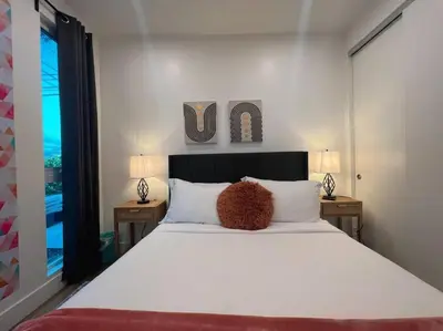 a bedroom with a large white bed with two lamps at Luminousness 4B3B Home in Torrance
