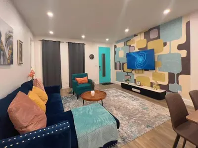 a living room with a blue couch and a tv at Luminousness 4B3B Home in Torrance