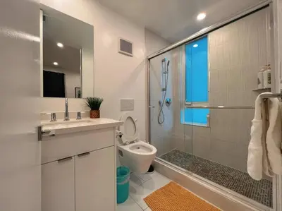 a bathroom with a shower and a sink and a toilet at Luminousness 4B3B Home in Torrance