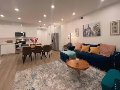 a living room with a blue couch and a table at Luminousness 4B3B Home in Torrance
