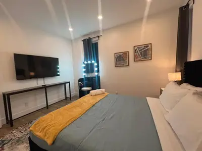 a bedroom with a large bed and a flat screen tv at Luminousness 4B3B Home in Torrance
