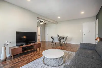 a living room with a couch and a tv and a table at Brentwood 1BR w Outdoor Pool nr UCLA Downtown LAX-188 in Los Angeles
