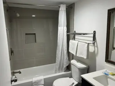 a bathroom with a shower and a toilet and a sink at Goldstar Inn in Los Angeles