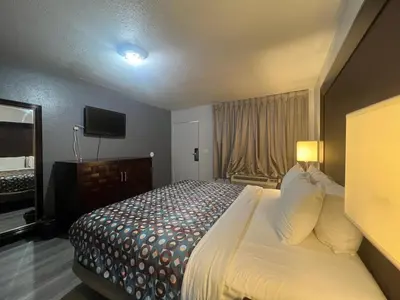 a hotel room with a bed and a television at Goldstar Inn in Los Angeles