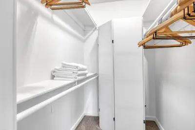a walk in closet with white walls and wooden shelves at Woodland Hills 2BR w Pool Gym nr Warner Center LAX-699 in Los Angeles