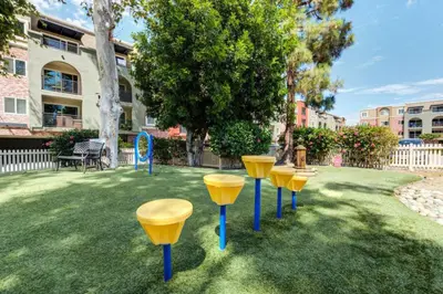 a row of yellow stools sitting in a yard at Woodland Hills 2BR w Pool Gym nr Warner Center LAX-699 in Los Angeles