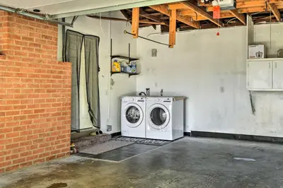 a washer and dryer in a room with a brick wall at San Gabriel Valley Hideaway! Family Home with Patio in Temple City