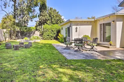 a patio with chairs and a table in a yard at San Gabriel Valley Hideaway! Family Home with Patio in Temple City