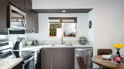 a kitchen with a sink and a table at Rock n Roll by AvantStay in Los Angeles