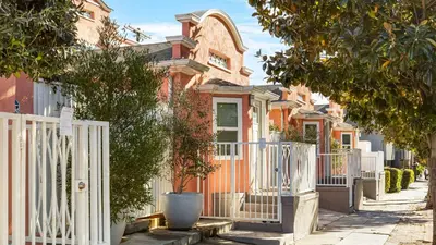 a row of houses with a white fence at Rock n Roll by AvantStay in Los Angeles