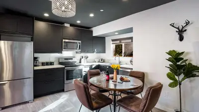 a kitchen with a table and chairs and a refrigerator at Rock n Roll by AvantStay in Los Angeles