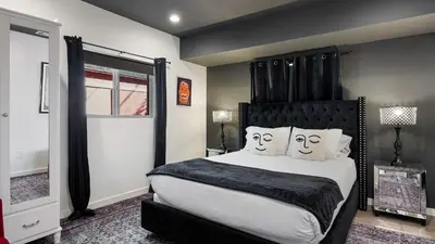 a bedroom with a large bed with two faces drawn on the pillows at Rock n Roll by AvantStay in Los Angeles
