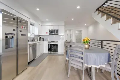 a kitchen with a table and chairs and a refrigerator at Modern Apartment in Studio City in Los Angeles