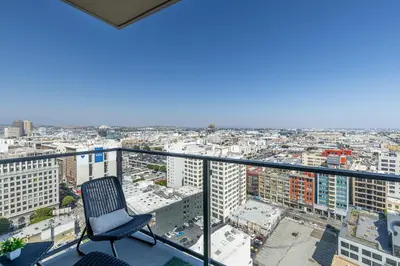 a chair sitting on the balcony of a building at Top Floor High Rise 3 Bed DTLA Skyscraper Penthouse in Los Angeles