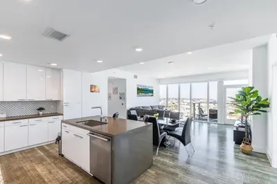 a kitchen and living room with a table and chairs at Top Floor High Rise 3 Bed DTLA Skyscraper Penthouse in Los Angeles