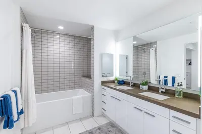 a white bathroom with two sinks and a bath tub at Top Floor High Rise 3 Bed DTLA Skyscraper Penthouse in Los Angeles