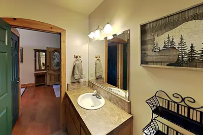 a bathroom with a sink and a mirror at Emerald Oasis in Lake Arrowhead