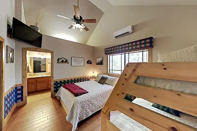 a bedroom with a bed and a ceiling fan at Emerald Oasis in Lake Arrowhead