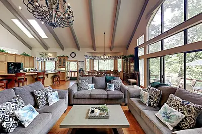 a large living room with couches and a table at Emerald Oasis in Lake Arrowhead